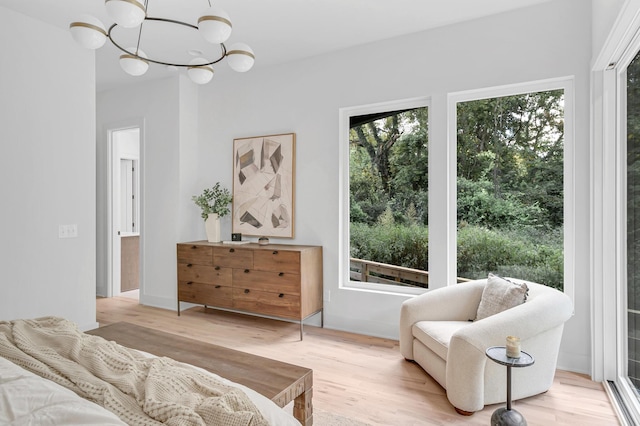 living area with light hardwood / wood-style floors and a chandelier