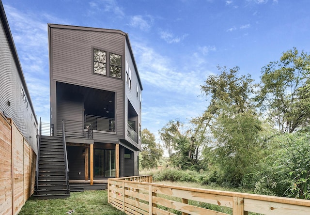 rear view of property featuring a balcony