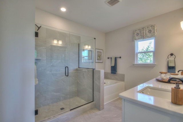 bathroom with shower with separate bathtub and vanity