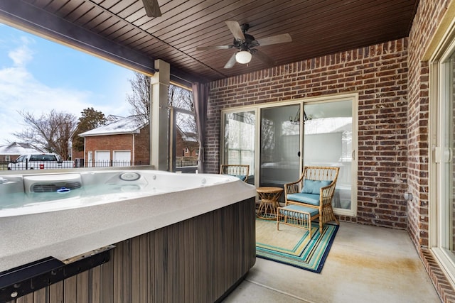 view of patio / terrace with a hot tub and ceiling fan