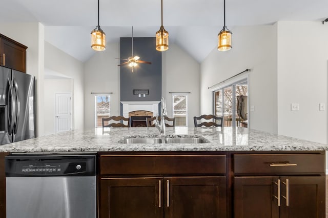 kitchen featuring lofted ceiling, appliances with stainless steel finishes, sink, and hanging light fixtures