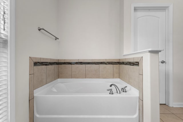 bathroom featuring a washtub and tile patterned floors