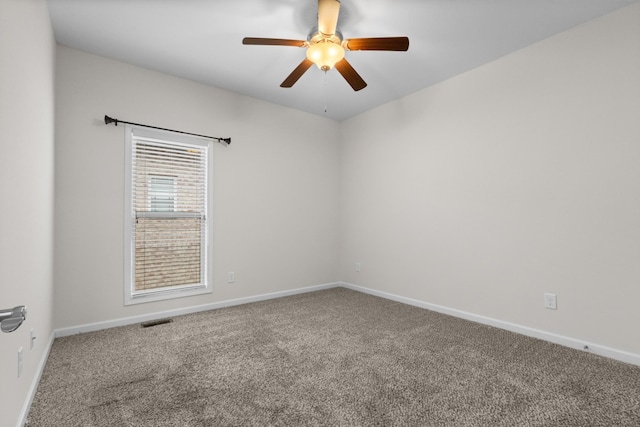 spare room with ceiling fan and carpet