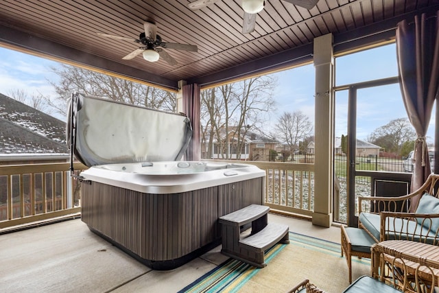 sunroom featuring a hot tub, ceiling fan, and wood ceiling