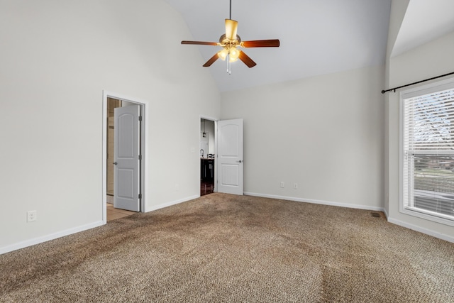 unfurnished bedroom featuring ceiling fan, high vaulted ceiling, and light carpet