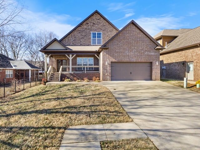 craftsman-style home featuring a garage, covered porch, and a front lawn