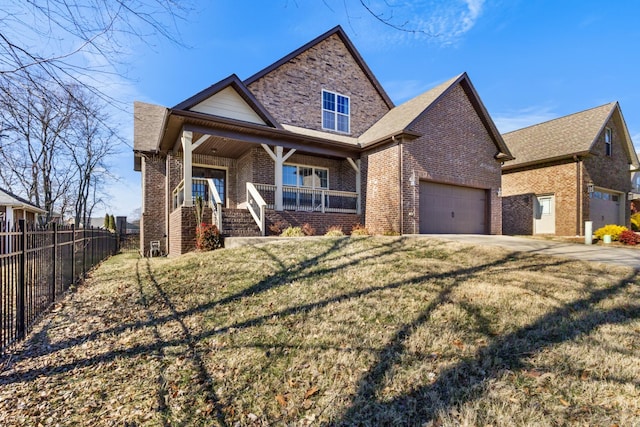 view of front of home with a garage, a front yard, and a porch