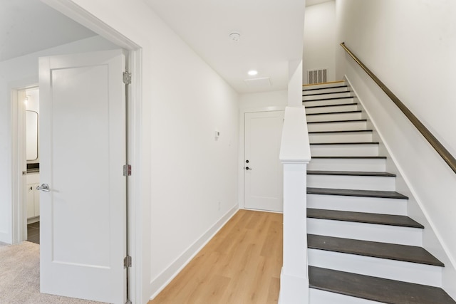 stairs featuring hardwood / wood-style flooring