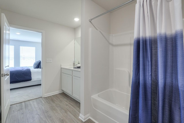 bathroom featuring vanity, hardwood / wood-style floors, and shower / bath combination with curtain