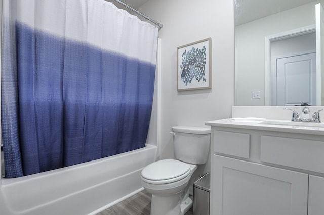 full bathroom featuring vanity, wood-type flooring, shower / bath combo with shower curtain, and toilet