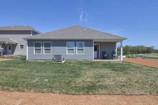 rear view of house featuring a yard, cooling unit, and a patio area