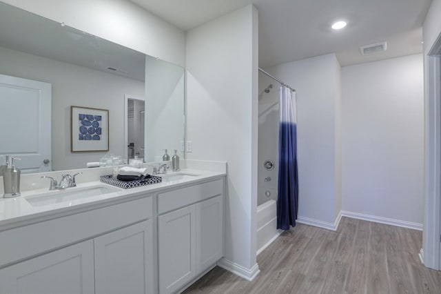 bathroom with vanity, hardwood / wood-style floors, and shower / bath combo with shower curtain