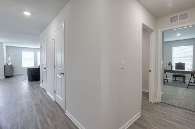 corridor with hardwood / wood-style floors