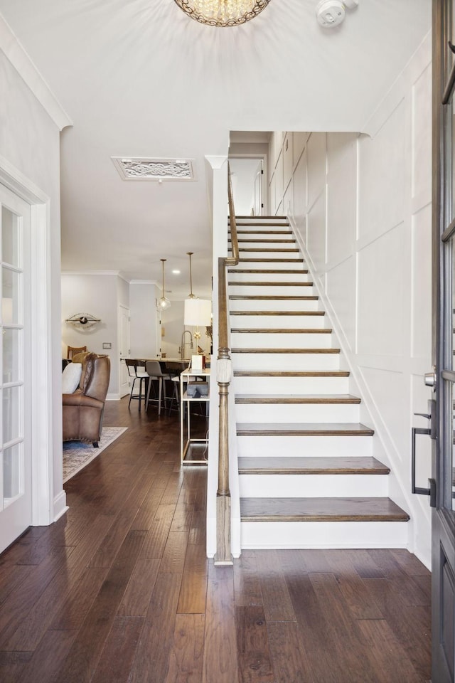 stairway with hardwood / wood-style flooring, sink, and ornamental molding