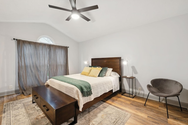 bedroom featuring hardwood / wood-style floors, vaulted ceiling, and ceiling fan