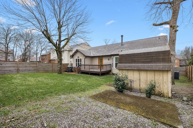 rear view of property with a deck, central AC unit, and a lawn