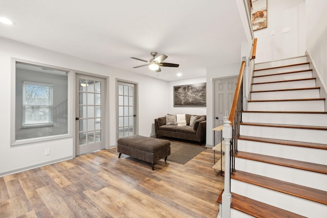 living room with ceiling fan and hardwood / wood-style flooring