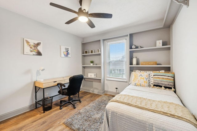 bedroom with light hardwood / wood-style flooring and ceiling fan