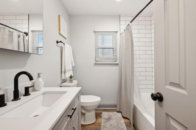 full bathroom with vanity, hardwood / wood-style flooring, toilet, and shower / tub combo with curtain