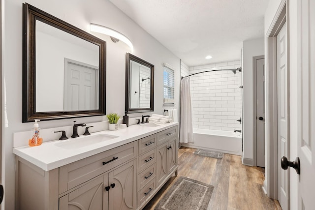 bathroom featuring hardwood / wood-style floors, shower / bath combo, and vanity