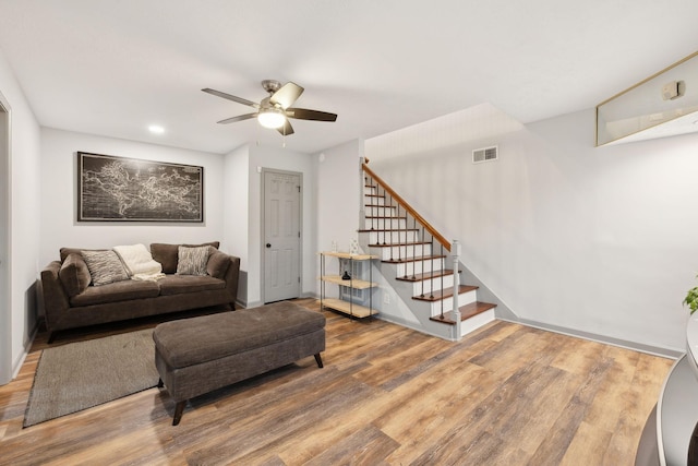 living room with hardwood / wood-style flooring and ceiling fan