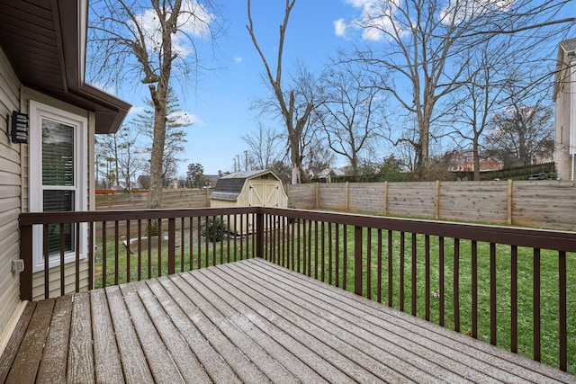 deck featuring a yard and a storage unit