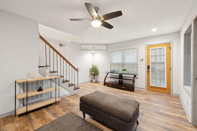 living room with ceiling fan and light hardwood / wood-style floors