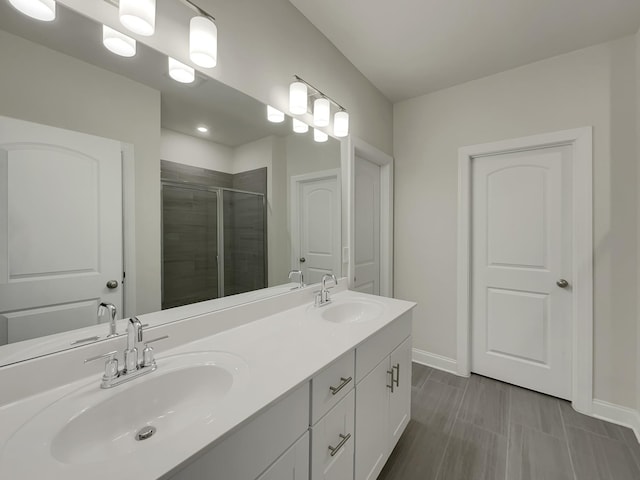 bathroom featuring vanity and an enclosed shower