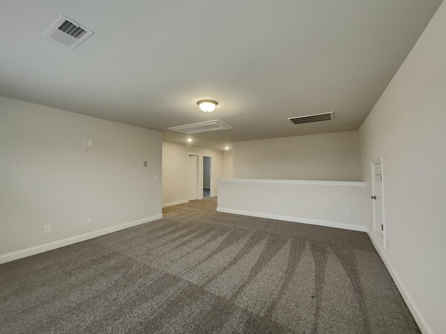 unfurnished room featuring dark carpet