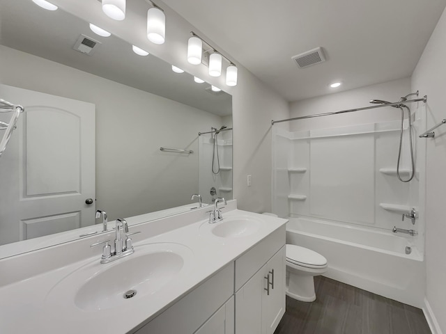 full bathroom featuring wood-type flooring, vanity, shower / bath combination, and toilet