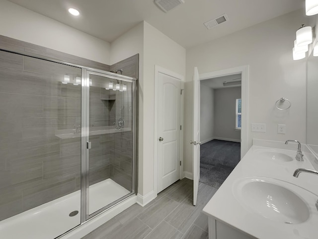 bathroom with vanity and a shower with shower door