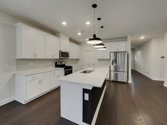 kitchen featuring a center island with sink, sink, white cabinetry, and stainless steel appliances