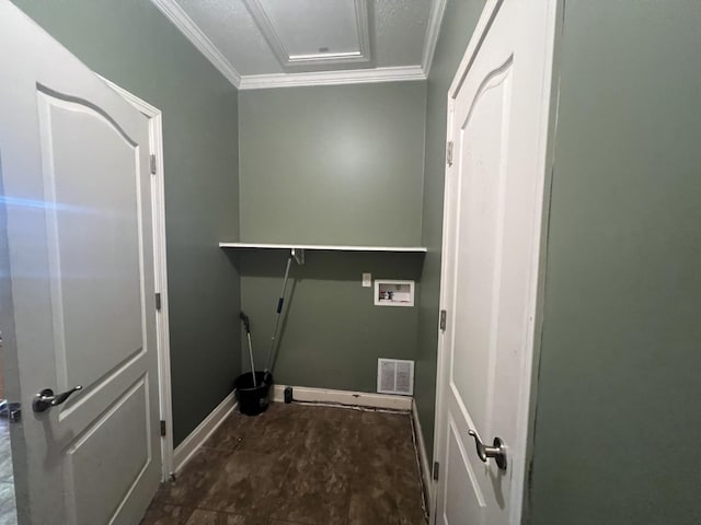 clothes washing area featuring crown molding, washer hookup, and a textured ceiling