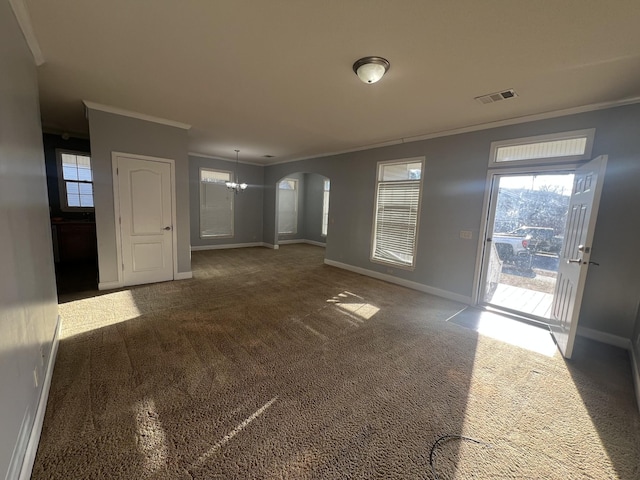 unfurnished living room featuring dark carpet, ornamental molding, and a chandelier