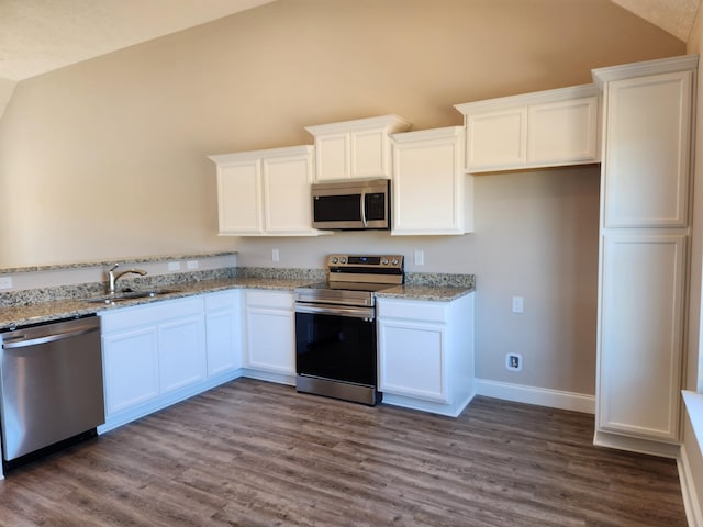 kitchen featuring white cabinetry, sink, light stone countertops, and appliances with stainless steel finishes