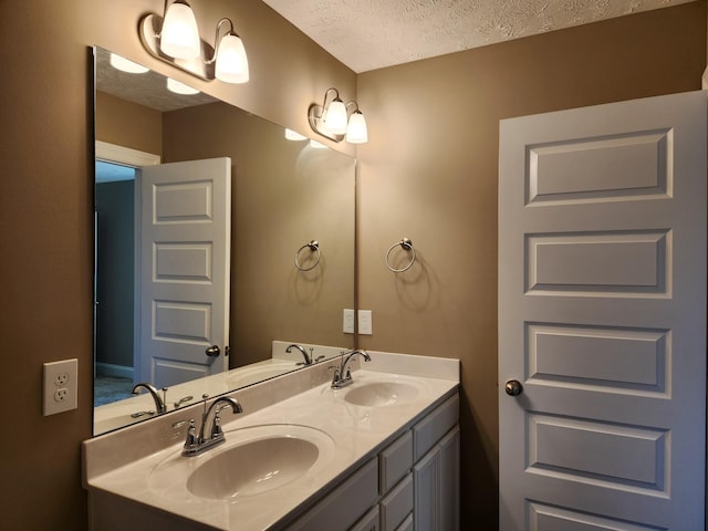 bathroom with vanity and a textured ceiling