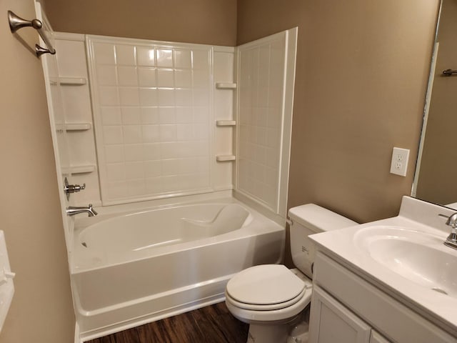 full bathroom with hardwood / wood-style floors, vanity, shower / bath combination, and toilet