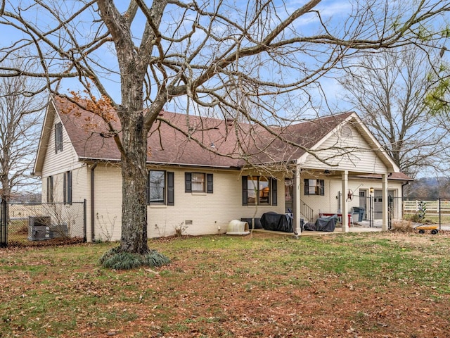 rear view of house with a patio area and a lawn