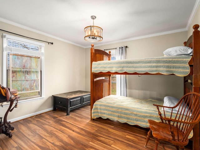 bedroom featuring a notable chandelier, wood-type flooring, and ornamental molding