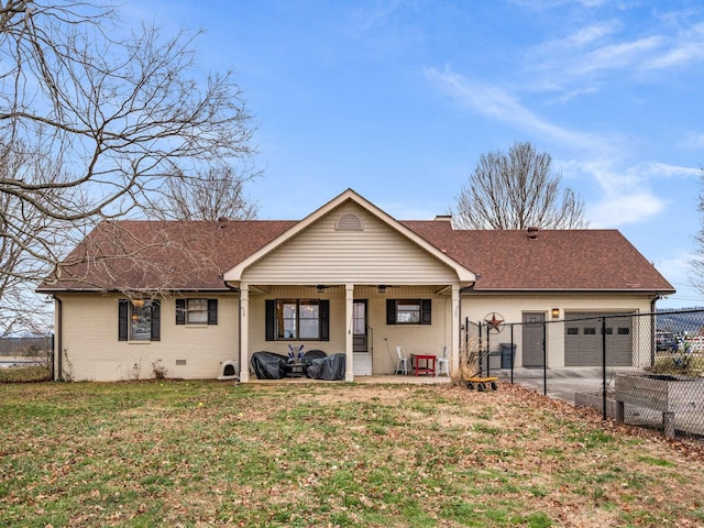 ranch-style house featuring a garage, covered porch, and a front yard