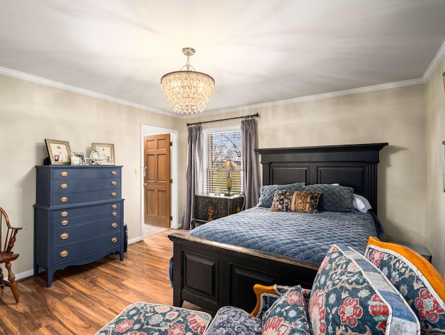 bedroom featuring ornamental molding, a chandelier, and hardwood / wood-style flooring