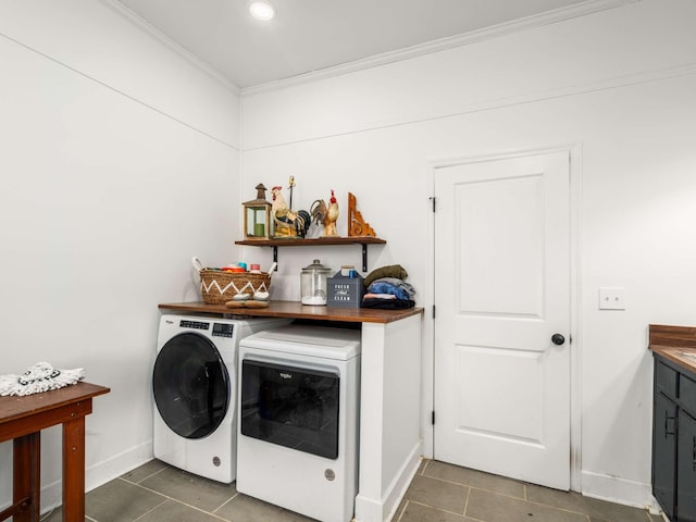 washroom with dark tile patterned floors, independent washer and dryer, and crown molding