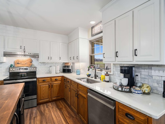 kitchen featuring wooden counters, tasteful backsplash, stainless steel appliances, sink, and white cabinetry