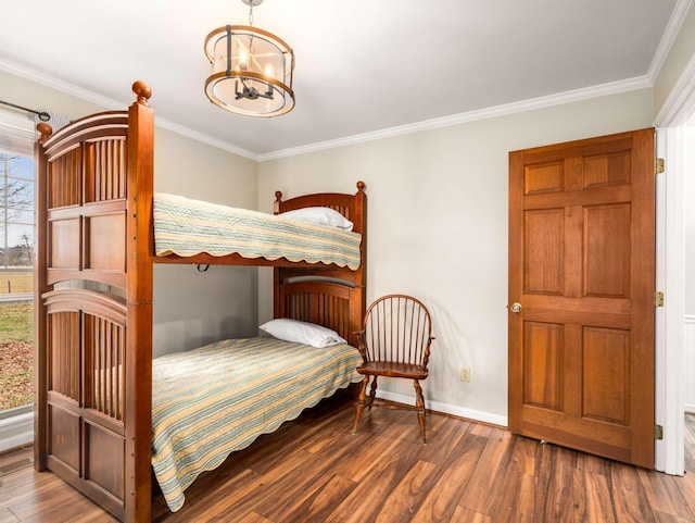 bedroom with a chandelier, dark hardwood / wood-style floors, multiple windows, and ornamental molding