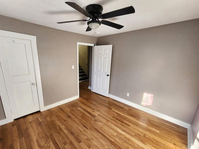 unfurnished bedroom with wood-type flooring and ceiling fan