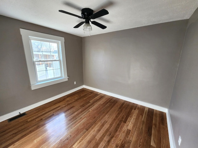 spare room featuring ceiling fan, wood-type flooring, and a textured ceiling