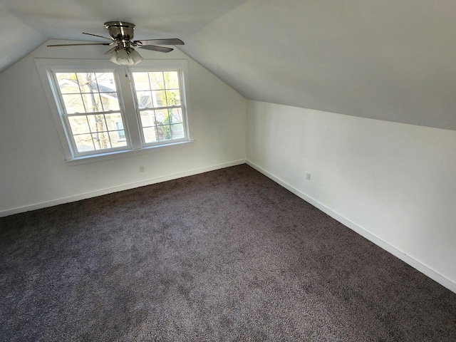 bonus room with dark carpet, ceiling fan, and lofted ceiling