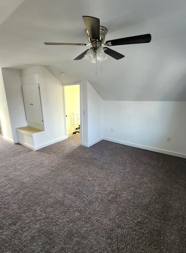 additional living space featuring carpet flooring, ceiling fan, and vaulted ceiling