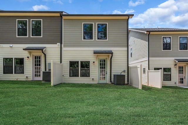 back of house featuring a yard and central AC unit