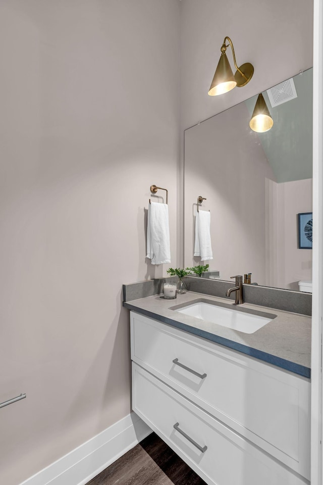 bathroom with hardwood / wood-style floors and vanity